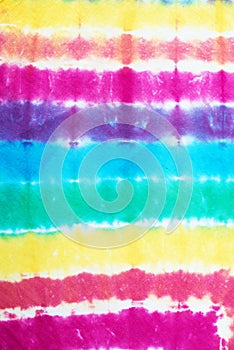 Colourful tie dyed pattern on cotton fabric abstract background.