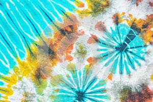 Colourful tie dyed pattern on cotton fabric background.