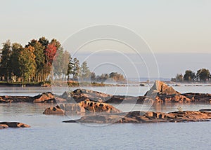 Colourful trees and rock formation at the shore of Lake Vanern photo