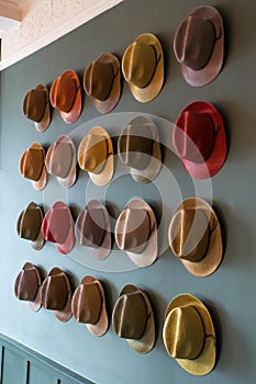 Colourful trilby hat collection, displayed on a wall
