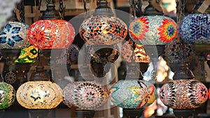 Colourful turkish lamps from glass mosaic glowing. Arabic multi colored authentic retro style lights. Many illuminated