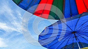 Colourful umbrellas and blue sky background