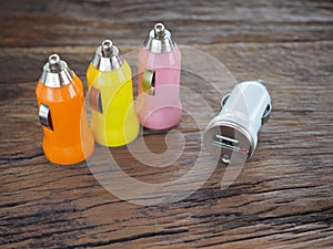 Colourful USB Car Charger on a wooden board with technology and energy concept