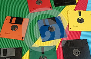 Colourful vintage floppy disks on contrast color background banner