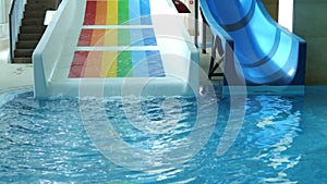 Colourful water slide in indoor swimming pool in hotel