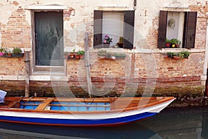 Colourful Wooden Boat Parked Outside Venice House, Italy