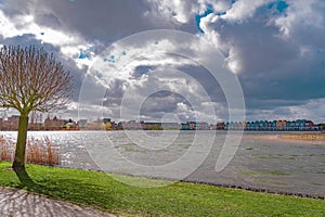 Colourful wooden lakeside houses De Rietplas. Modern residential architecture in Houten, The Netherlands