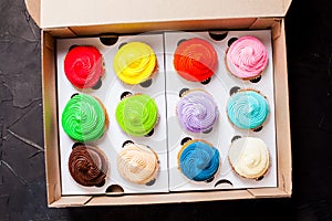 Colourfull rainbow cupcakes top view in the box