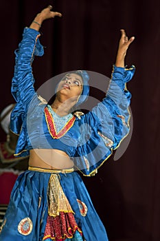 A colourfully dressed female performer at the Esala Perahera theatre performance in Kandy, Sri Lanka.