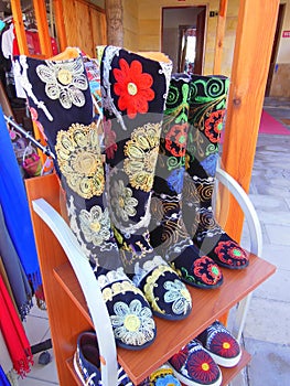 Colourfully embroidered boots and shoes photo