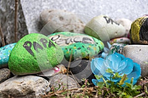 Colourfully Painted Rocks by a Grave