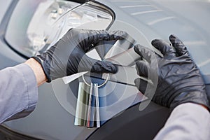 Colourist man selecting color of car with paint matching samples photo