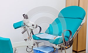 Colposcope and chair in the gynecology office. Selective focus photo