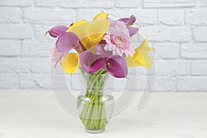 Colrful diasies and lilies flowers arranged in a vase