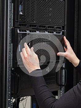 Colse-up of a IT consultant installing server in datacenter