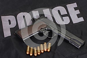 colt m1911 handgun with ammo on police uniform