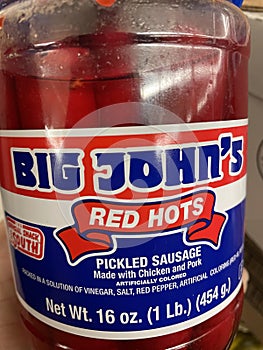 Big Johns Red hots sausage in a jar on a shelf close up