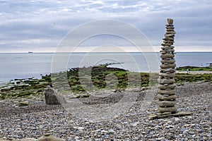 Column built from rocks on the beach