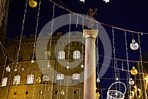 Column, in the dark of the evening, supports the statue which represents a