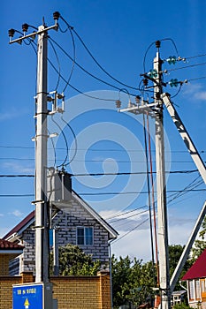 Column electrical power lines on sky background