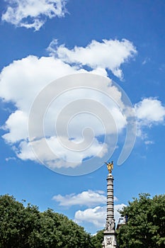 Column with gold statue at Fountain of Chatelet in Paris, France