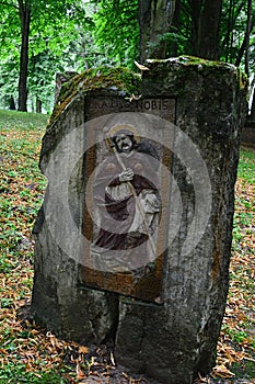 Column with religious icon and sentence `Ora Pro Nobis` on top, placed on Island Of Art in center of Orava River Dam