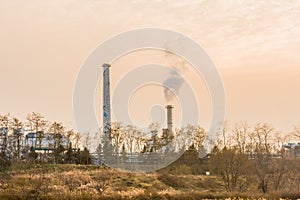 Column of smoke rising from tall white smokestack