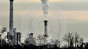 Column of smoke rising from tall white smokestack