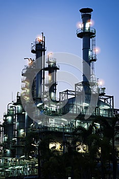 Column tower in petrochemical plant at twilight.