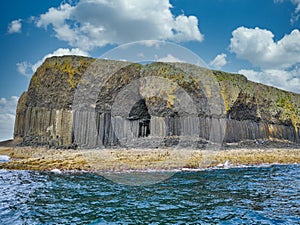 Columns of jointed volcanic basalt rocks on the island of Staffa in the Inner Hebrides, Scotland photo