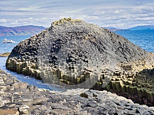 Columns of jointed volcanic basalt rocks on the island of Staffa in the Inner Hebrides, Scotland photo