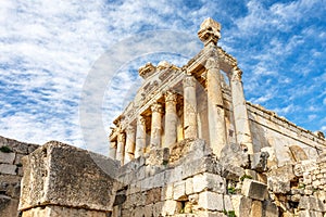 Columns of ancient Roman temple of Bacchus with surrounding ruins and blue sky in the background, Beqaa Valley, Baalbeck, Lebanon