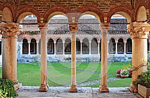 Columns and arches in the medieval cloister of Saint Zeno