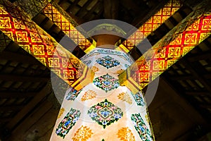 Columns and beams decorated in traditional Thai style at a temple in Nakhon Sawan Province