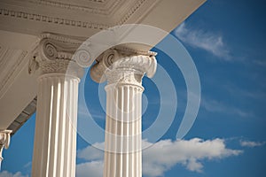 Columns on blue sky background.