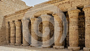 Columns with capitals and reliefs on the left side of the first court of his Mortuary Temple.