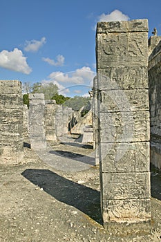 Columns with carved stonework on the Temple of the Warriors at the ancient Mayan city of Chichen Itza, in Yucatan, Mexico photo