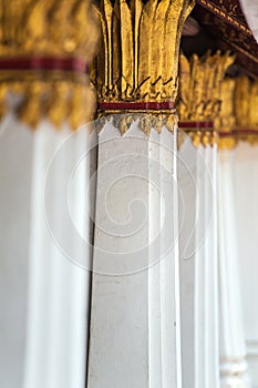 Columns decorated with gold plated ornament in Thai temple