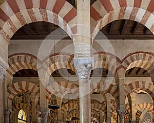 Columns and double-tiered arches of the Mosque-Cathedral of Cordoba in the Spanish region of Andalusia, Spain.