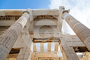 Columns of entrance propylaea to ancient temple Parthenon in Acropolis Athens Greece on blue sky background.