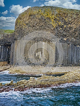 Columns of jointed volcanic basalt rocks on the island of Staffa in the Inner Hebrides, Scotland
