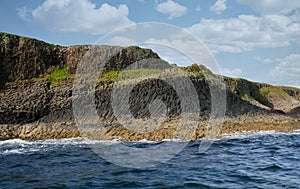 Columns of jointed volcanic basalt rocks on the island of Staffa in the Inner Hebrides, Scotland