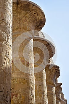 Columns of Karnak Temple complex with carved ancient Egyptian hieroglyphs and symbols. Great hypostyle hall in temples of Karnak