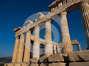 Columns of Parthenon temple on Acropolis, Athens, Greece at sunset against blue sky