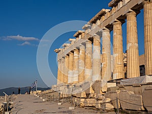 Columns of Parthenon temple on Acropolis, Athens, Greece at sunset against blue sky