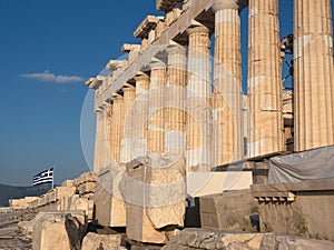 Columns of Parthenon temple on Acropolis, Athens, Greece at sunset against blue sky