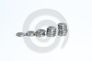 Columns of silver gold coins on a white background