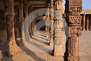 Columns with stone carving in courtyard of Quwwat-Ul-Islam mosque, Qutub Minar, Delhi, India