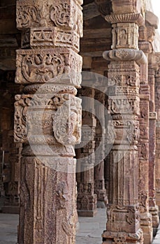 Columns with stone carving in courtyard of Quwwat-Ul-Islam mosque, Qutab Minar complex, Delhi