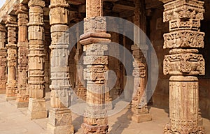 Columns with stone carving in courtyard of Quwwat-Ul-Islam mosque, Qutab Minar complex, Delhi